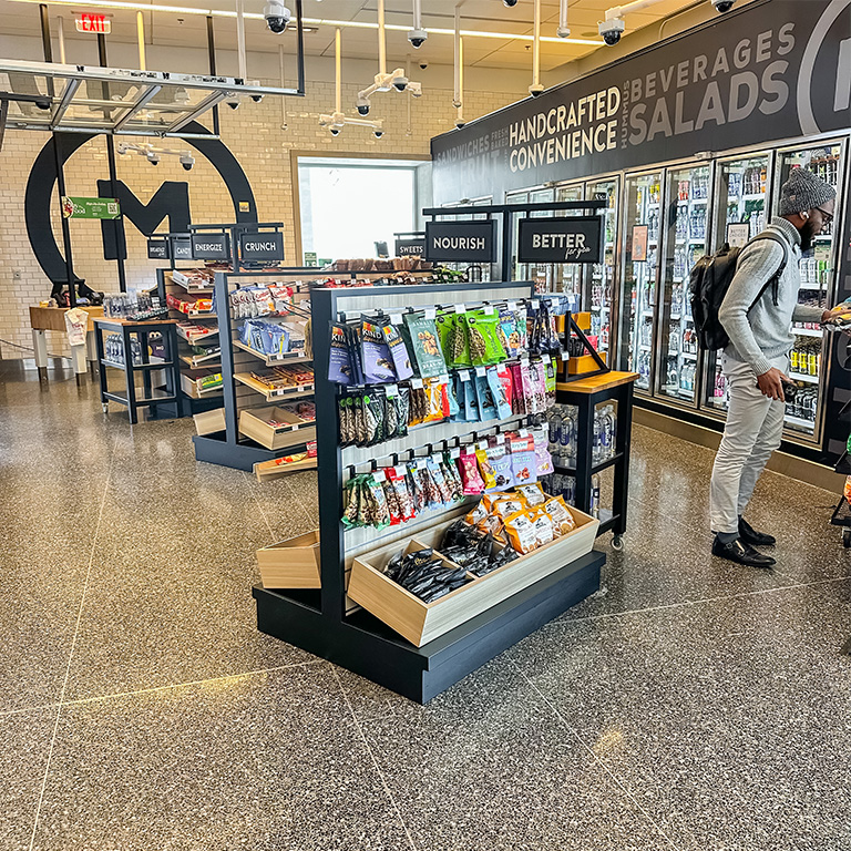 Photo of the Market in the Campus Center displaying their logo in the background.